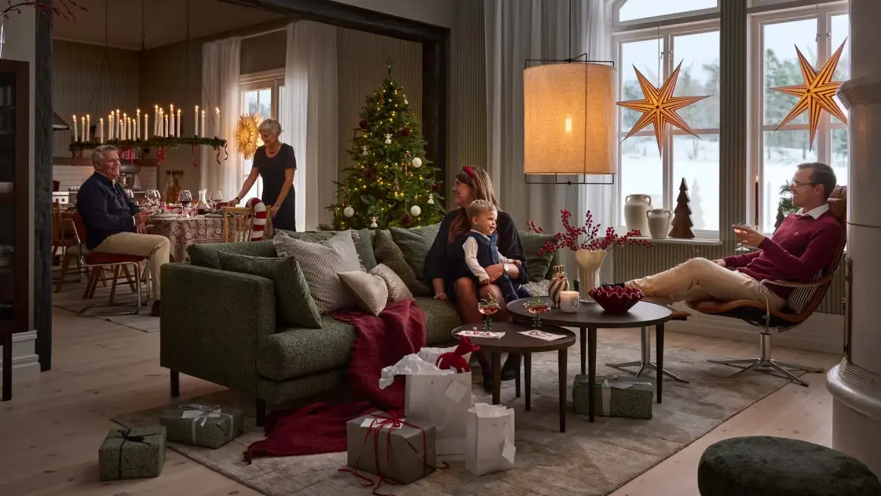 En familj njuter av en mysig julkväll med en sprakande brasa med lugn julmusik. Presenter och julgran bidrar till stämningen.