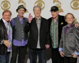 Fem leende medlemmar av The Beach Boys poserar för ett foto.