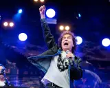 Magnus Uggla show Stockholm. Sångaren med knuten näve i luften, full av energi på scenen.